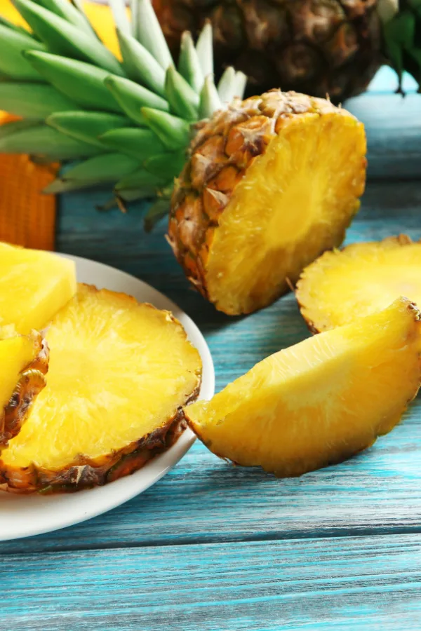 A pineapple that has been sliced into.